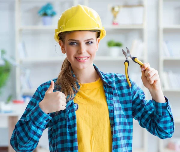 Woman in workshop with pliers