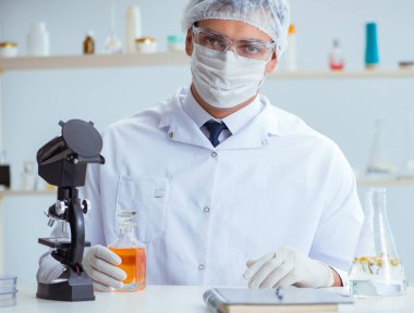 Laboratuvarda parfüm karıştıran bir kimyager.