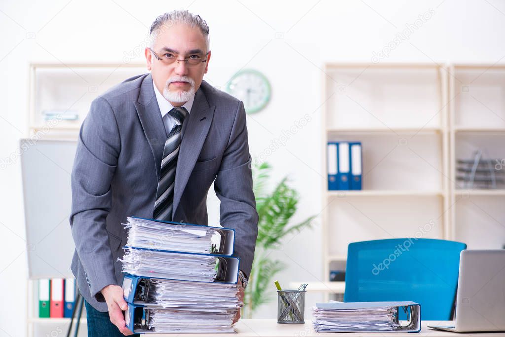 Aged male employee unhappy with excessive work