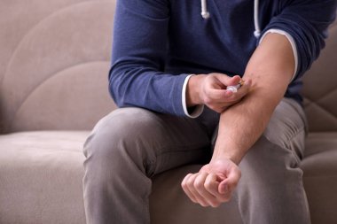 Evde narkotikle sorunları olan genç bir adam.