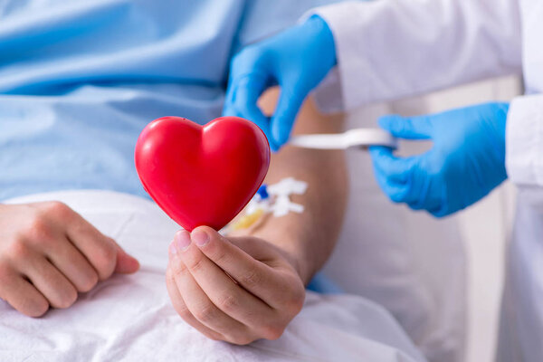 Male patient getting blood transfusion in hospital clinic