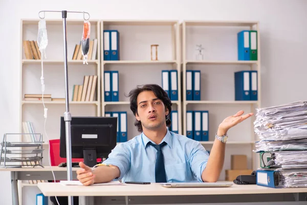 Young male employee in blood transfusion concept — Stock Photo, Image