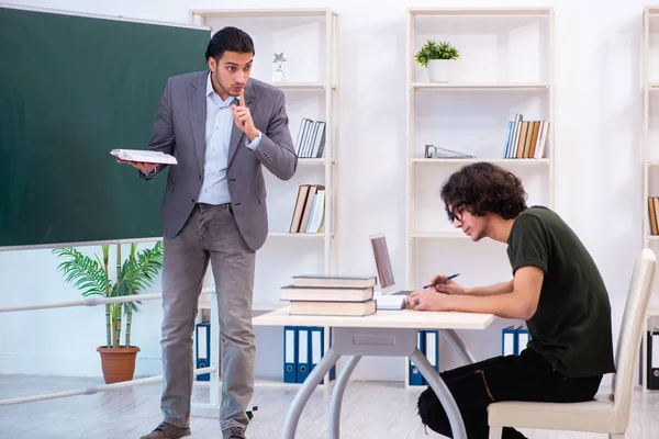Young teacher and student in the classroom — Stock Photo, Image