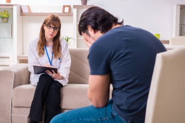 Genç bir erkek hasta kadın psikologla konuşuyor.