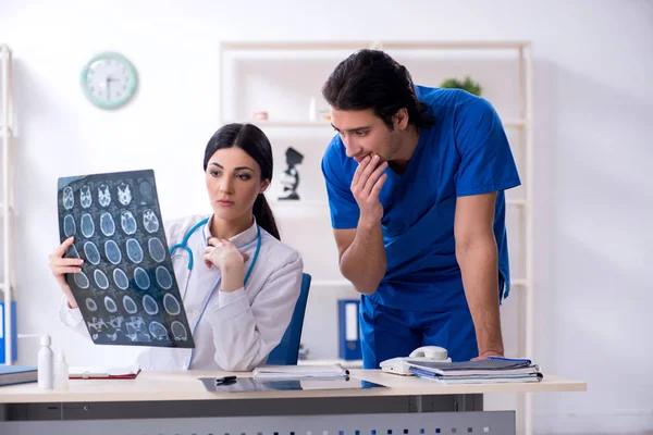 Two young doctors working in the clinic — Stock Photo, Image