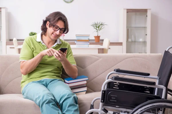 stock image Young male student in wheelchair at home