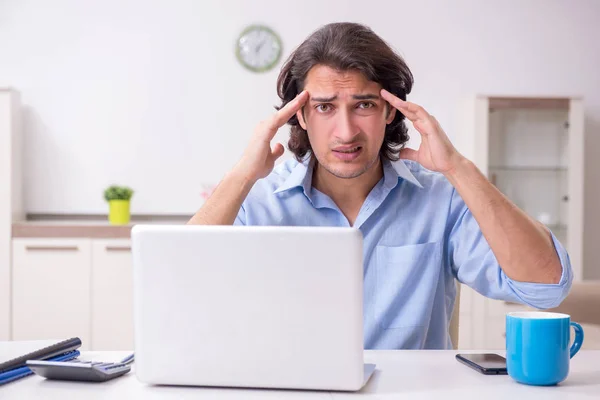 Young male employee working at home — Stock Photo, Image