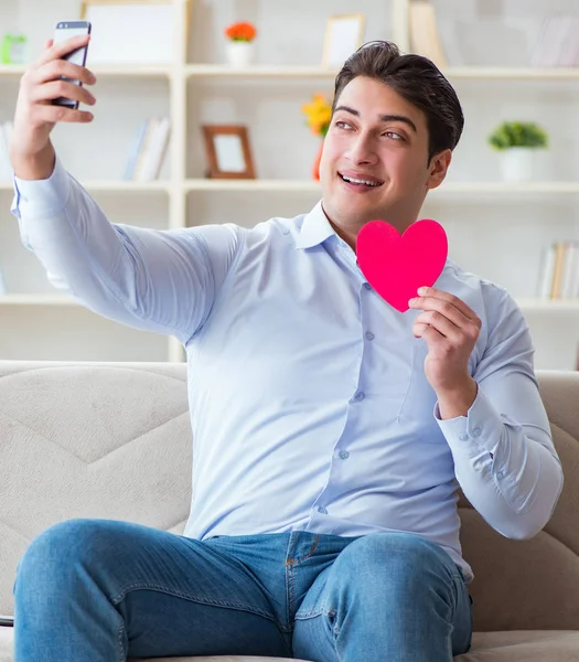 Young man chatting with his sweetheart over mobile phone