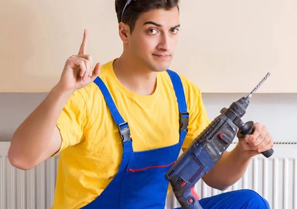 Young repairman contractor repairing heating panel — Stock Photo, Image