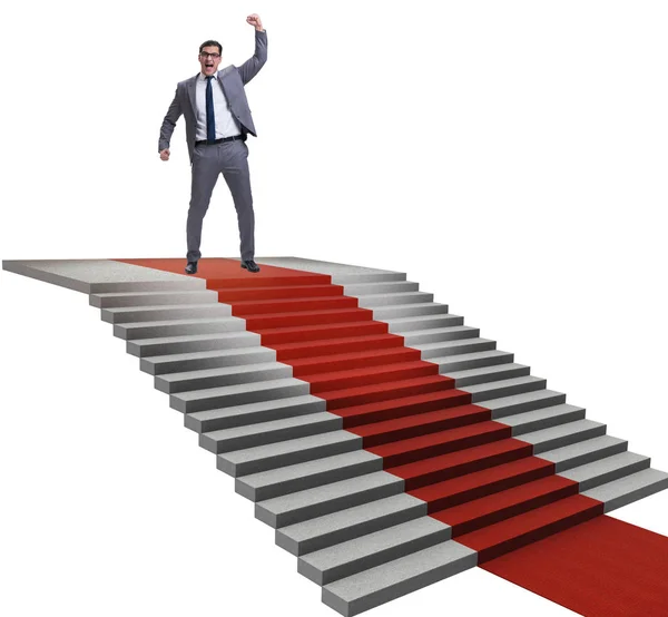 Young businessman climbing stairs and red carpet on white backgr — Stock Photo, Image