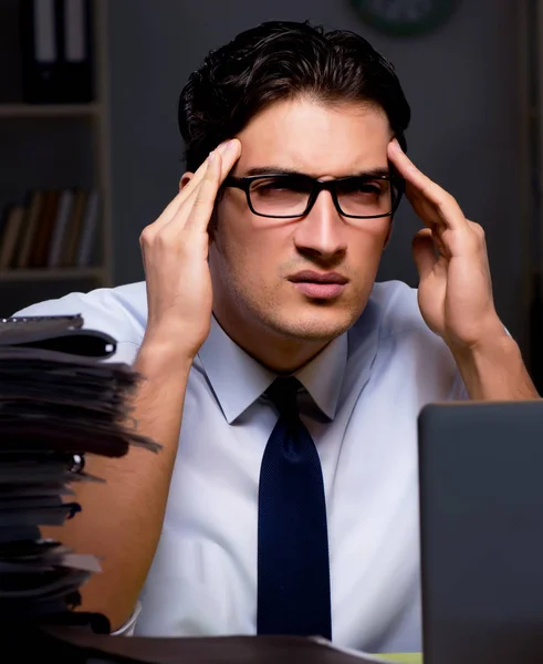 Young businessman working overtime late in office