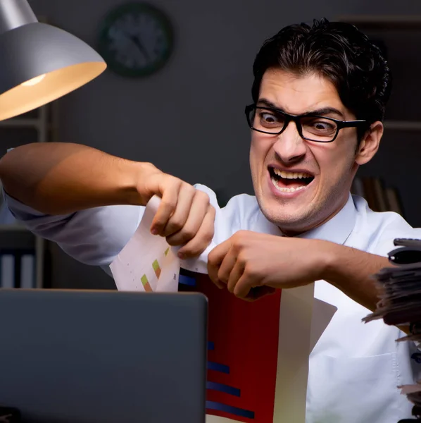 Young businessman working overtime late in office