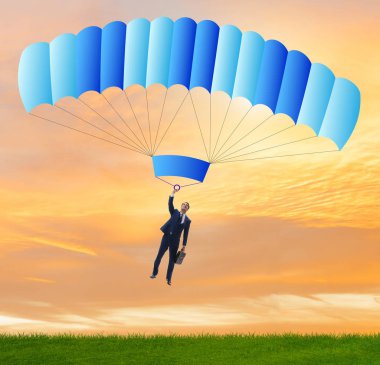 Genç işadamı iş konseptinde paraşütle atlıyor