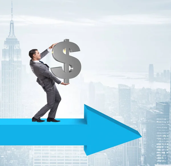 Businessman with dollar walking on arrow sign — Stock Photo, Image