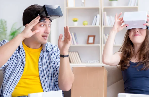 Young family playing games with virtual reality glasses