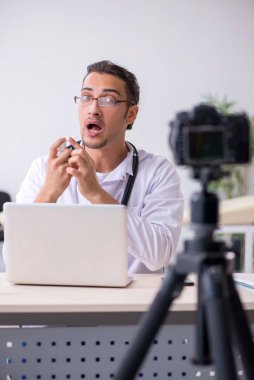 Genç erkek doktor blogu için video kaydediyor.