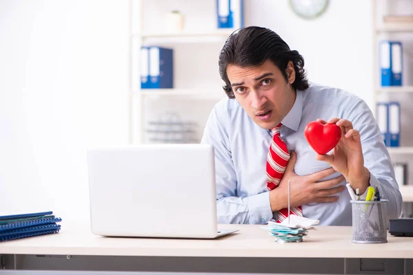 Young male employee suffering in the office — Stock Photo, Image