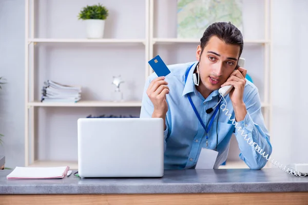 Young male travel agent working in the office — Stock Photo, Image