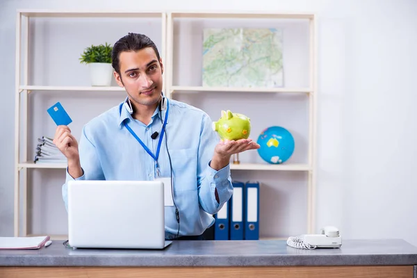 Young male travel agent working in the office