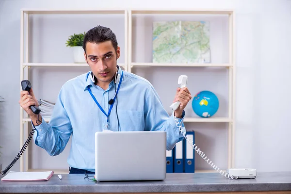 Mladý muž cestovní agent pracující v kanceláři — Stock fotografie