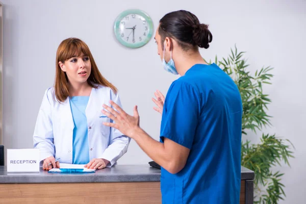 Two doctors working at the reception in the hospital