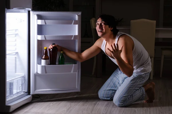 Man breaking diet at night near fridge — Stock Photo, Image