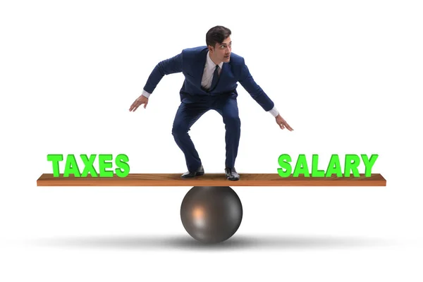 Businessman balancing between taxes and salary — Stock Photo, Image