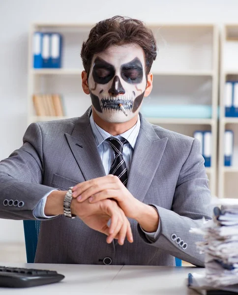 Businessmsn con maschera viso spaventoso che lavora in ufficio — Foto Stock