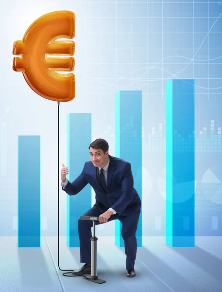 The businessman pumping euro sign in business concept — Stock Photo, Image