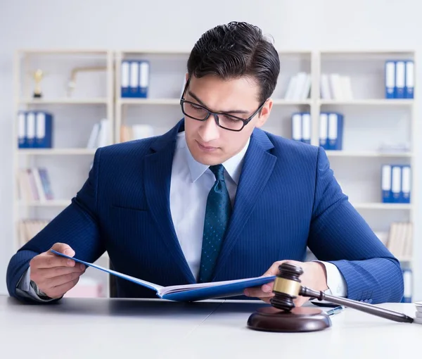 Young lawyer judge sitting in the office