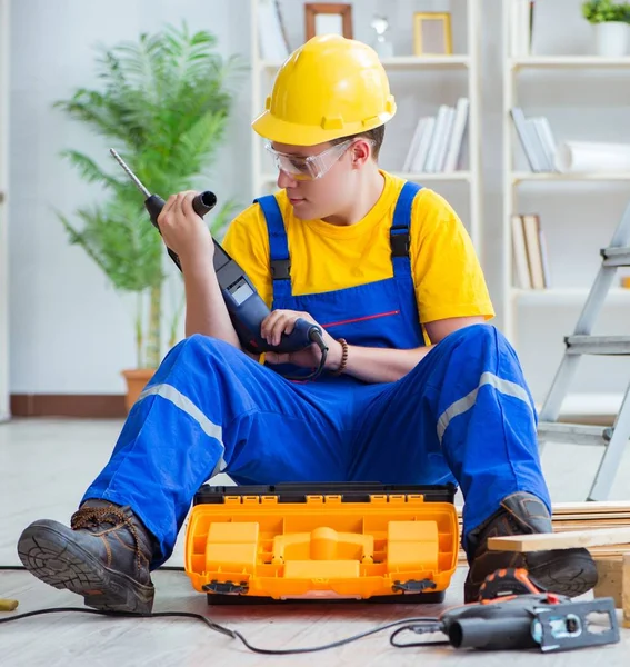 Der junge Mann beim Zusammenbau von Holzpaletten — Stockfoto