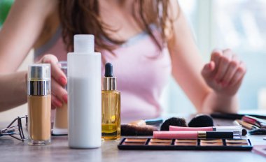 Güzellik konseptinde makyaj malzemeleri olan bir kadın.