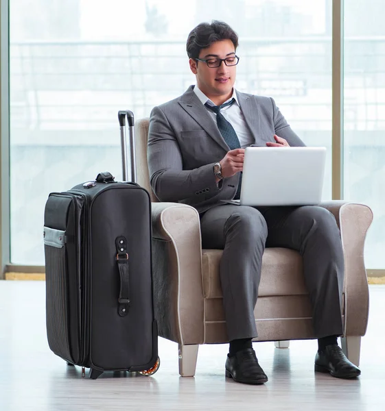 Young businessman in airport business lounge waiting for flight