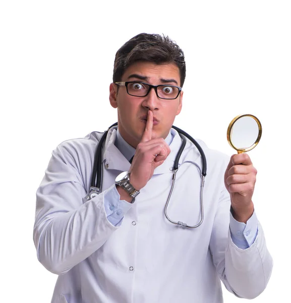 Young male doctor with a looking magnifying glass isolated on wh — Stock Photo, Image