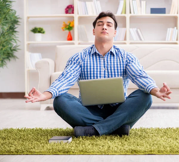 Young handsome man sitting on floor at home — Stock Photo, Image