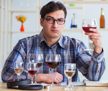 Profesyonel şarap garsonu kırmızı şarap tadıyor.