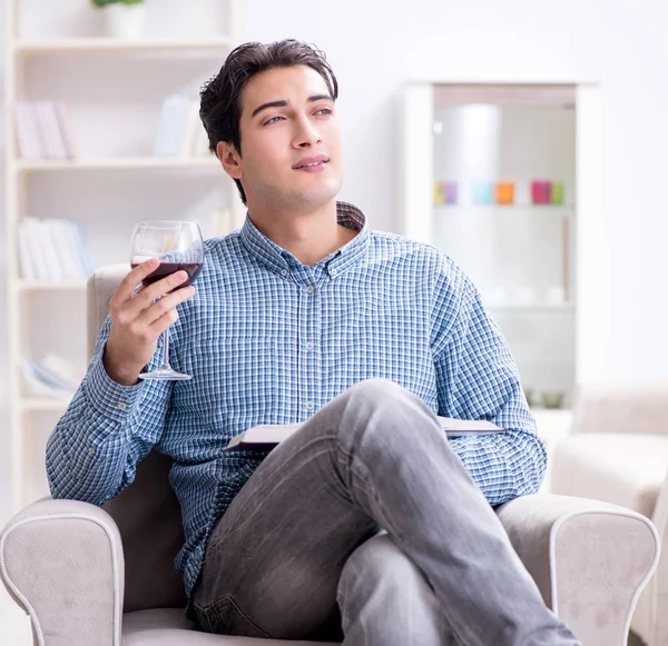Young man drinking wine at home — Stock Photo, Image