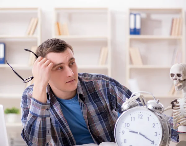 Student and skeleton preparing for school exams — Stock Photo, Image