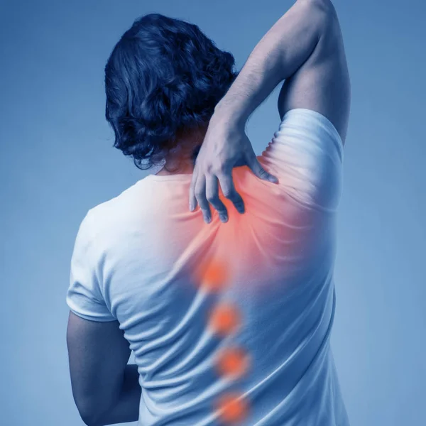 Man suffering from acute pain in spine back