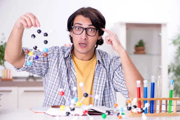 Young student physicist preparing for exam at home — Stock Photo, Image