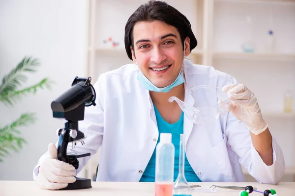 Jonge mannelijke chemicus werkzaam in het lab — Stockfoto