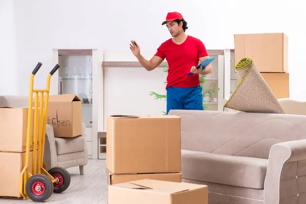 Young male contractor with boxes working indoors — Stock Photo, Image