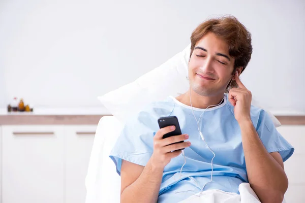 Young male patient lying on couch in hospital