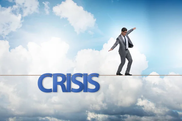 Crisis concept with businessman walking on tight rope — Stock Photo, Image