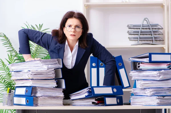 Middle-aged businesswoman unhappy with excessive work — Stock Photo, Image