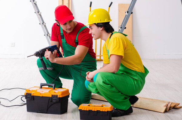 Two workers contractors working indoors