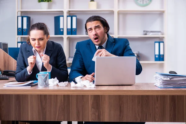 Two employees suffering at workplace — Stock Photo, Image