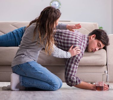 Genç bir aile kavramında içki sorunu yaşayan sarhoş bir koca.