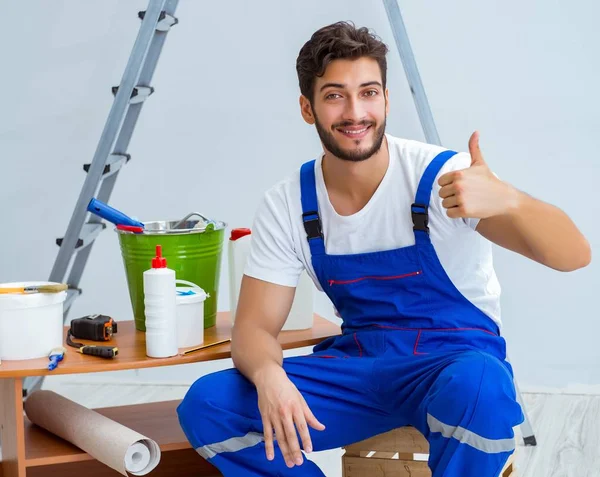 Reparateur bei Renovierungsarbeiten im Haus mit Papiertapete — Stockfoto