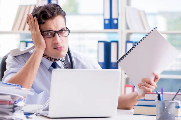 Young businessman under pressure in office to deliver tasks